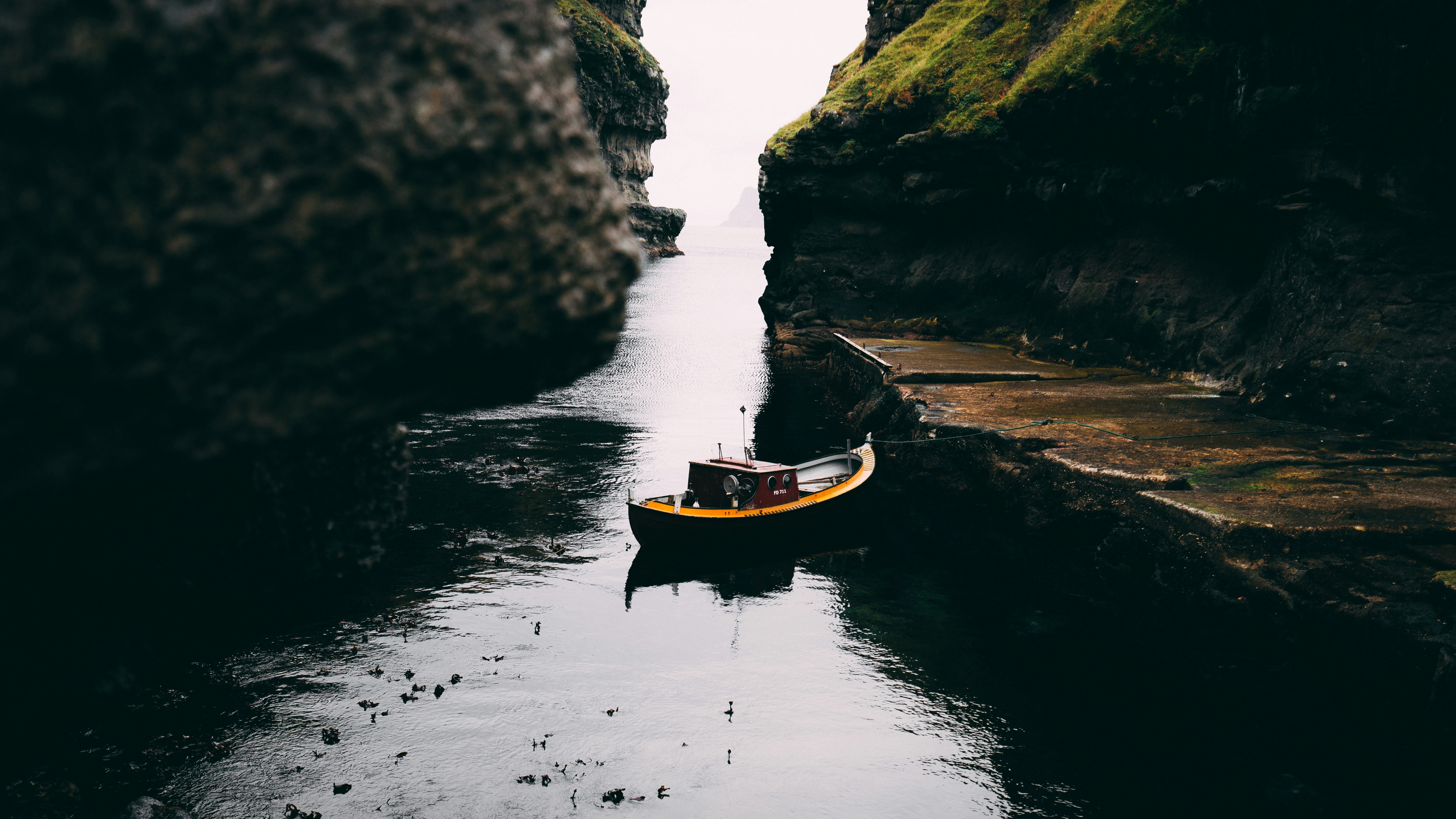 boat on water between rock formations